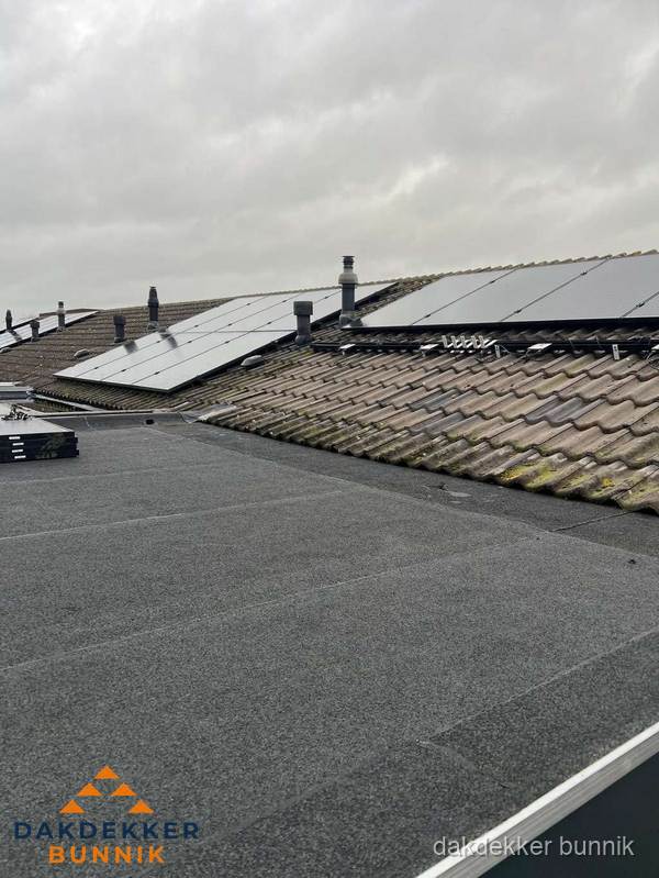 Bitumen dakbedekking op plat dak met aansluitend pannendak en zonnepanelen in Bunnik